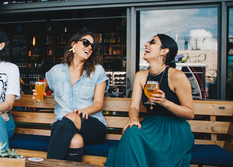 Friends enjoying craft beers on a sunny patio
